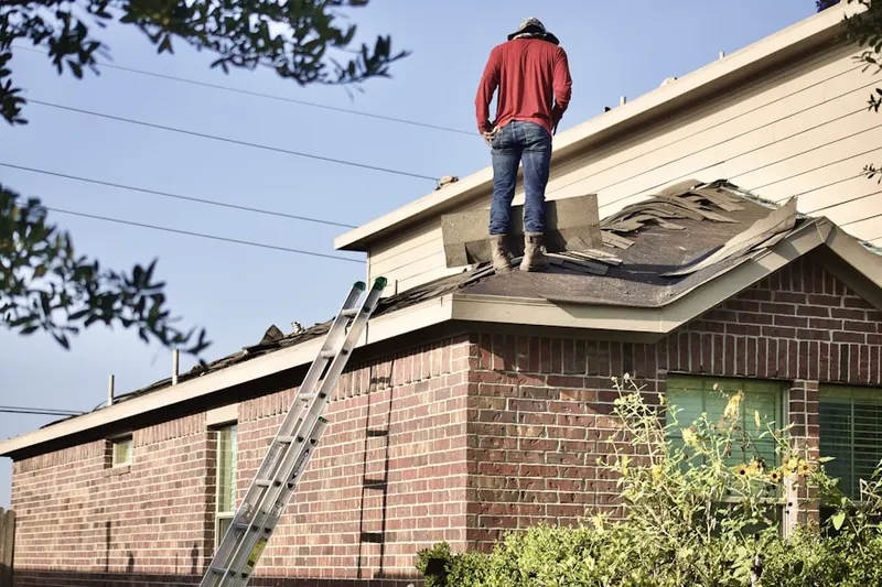 Professional roofer working on a residential roof in Wells Branch